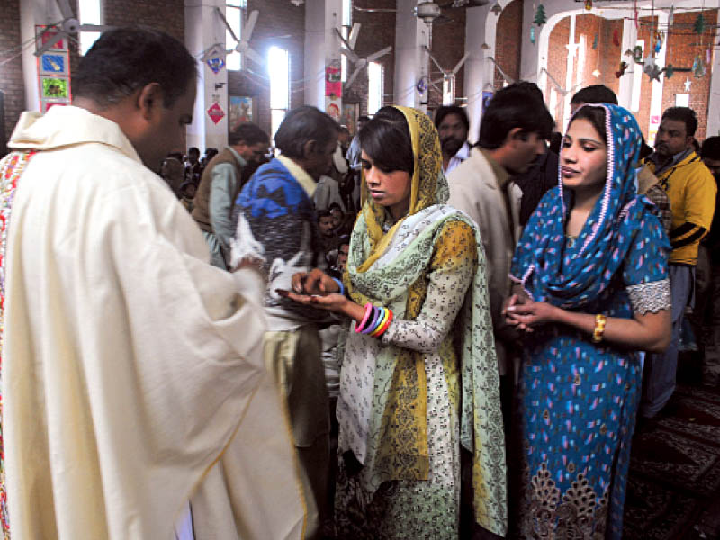 Christians attend a ceremony at St. Michael Catholic Church in Peshawar on Tuesday. PHOTO: MUHAMMAD IQBAL/EXPRESS