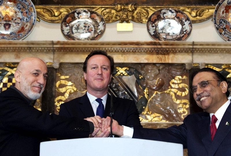 Britain's Prime Minister David Cameron (C) shakes hands with Afghan President Hamid Karzai (L) and Pakistani President Asif Ali Zardari (R) at Chequers, the Prime Minister's official country residence, near Aylesbury in Buckinghamshire, west of London, on February 4, 2013. PHOTO: AFP