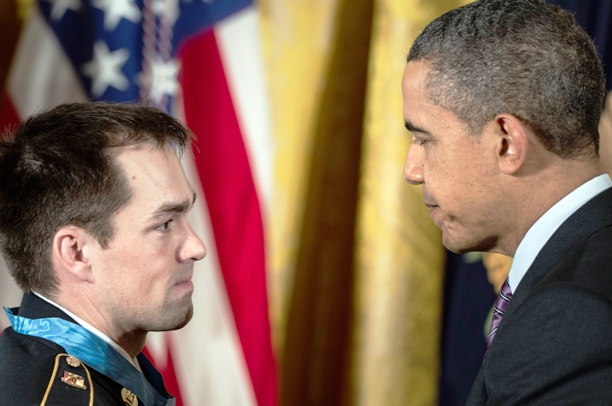 US President Barack Obama thanks US Army Staff Sargent Clinton Romesha during a Medal of Honor ceremony in the East Room of the White House February 11, 2013. PHOTO: AFP