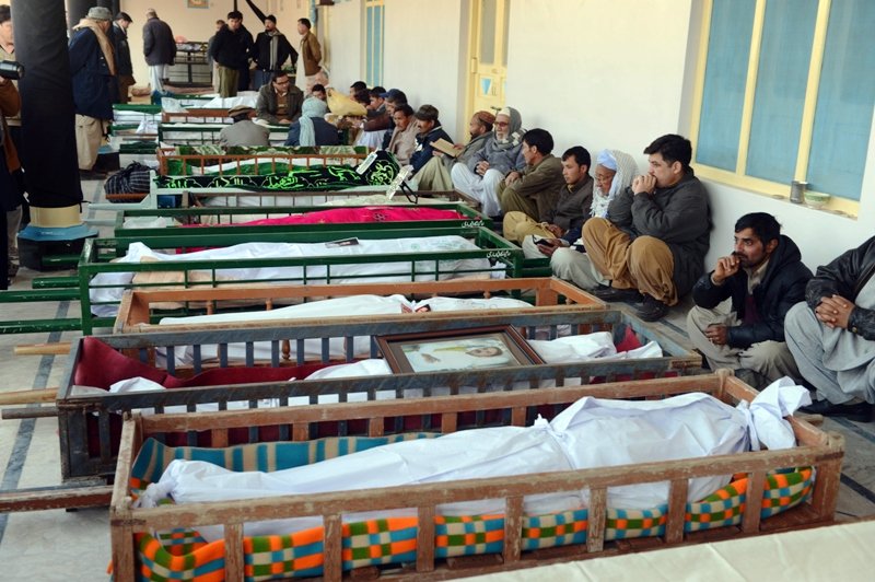 File photo of Shia Muslim mourners sit beside the coffins of blast victims at a mosque. PHOTO: AFP/FILE