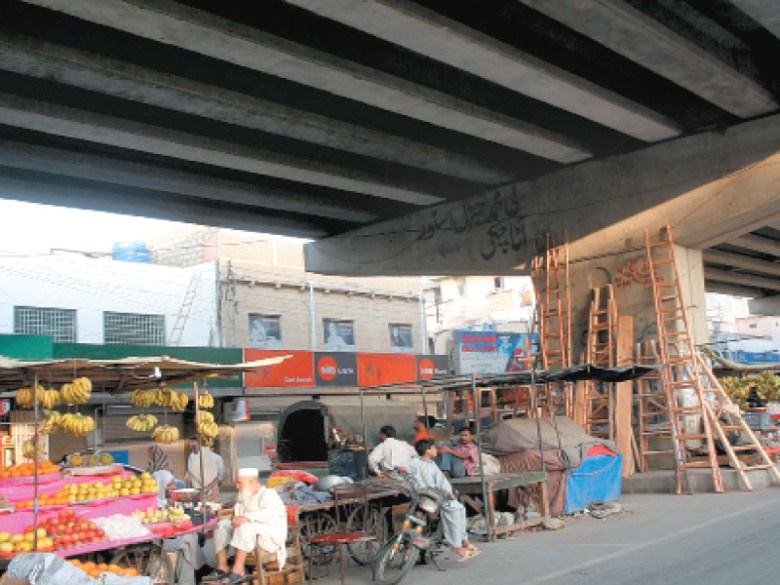 Encroachers running their businesses under the flyover at GIzri, which most often causes a traffic mess. PHOTO: ATHAR KHAN/EXPRESS