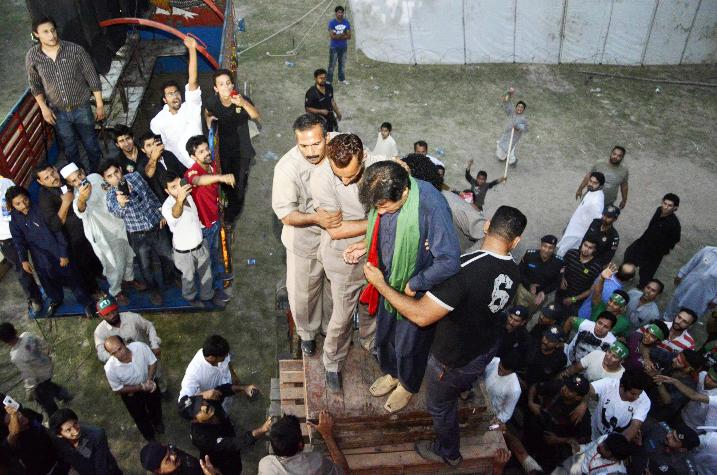 PTI Chairman, moments before he fell off the lifter. PHOTO: PTI SOCIAL MEDIA TEAM