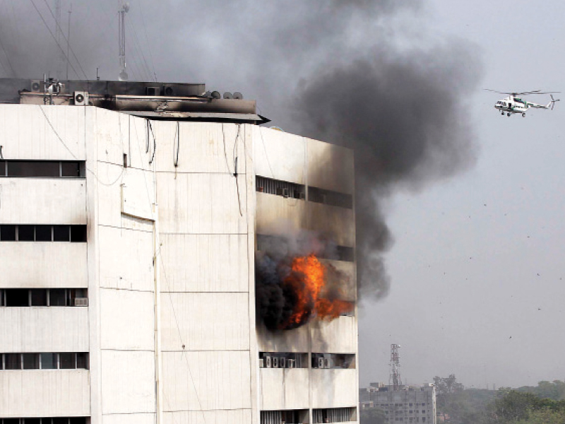 Some 50 people ended up trapped inside the building. Some were rescued, some were killed attempting to escape the flames by jumping out the window, and others were killed by smoke or fire. . PHOTO: SHAFIQ MALIK, ABID NAWAZ/EXPRESS