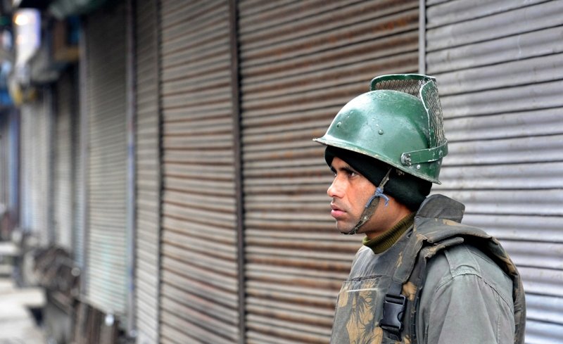An Indian paramilitary soldier stands guard during a strike in Srinagar on February 16, 2013. PHOTO: AFP