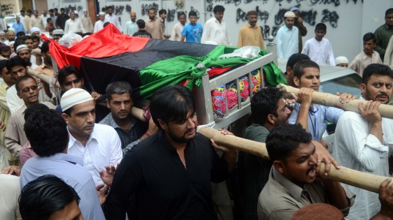 Supporters of Pakistan People's Party (PPP) carry the coffin of senior security officer Bilal Sheikh during his funeral in Karachi on July 11, 2013. PHOTO: AFP