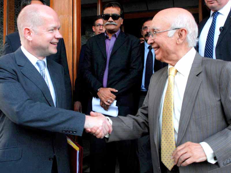Adviser to PM on Foreign Affairs Sartaj Aziz and British Foreign Secretary William Hague shake hands after their joint news conference. PHOTO: ONLINE