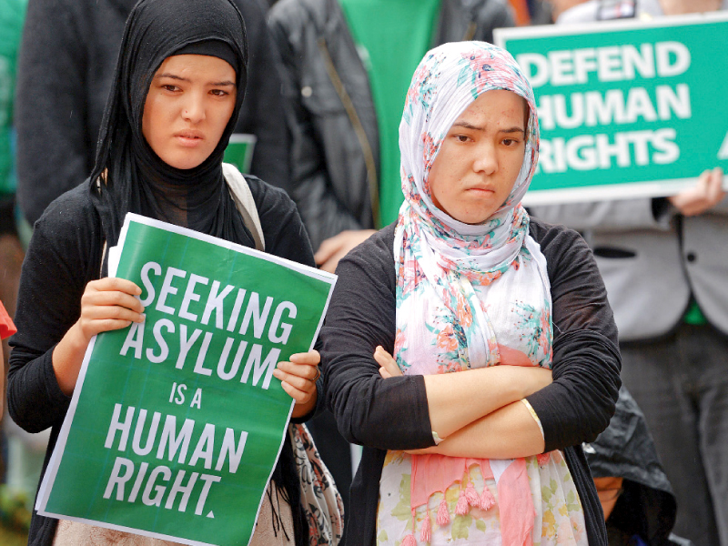 A Hazara woman holds a poster during a rally in support of asylum seekers in Sydney. PHOTO: AFP