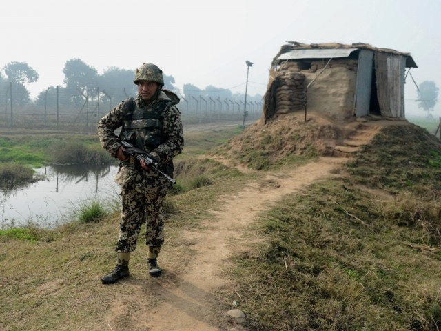An Indian Border Security Force (BSF) soldier keeps watch at an outpost along the India-Pakistan border. PHOTO: AFP