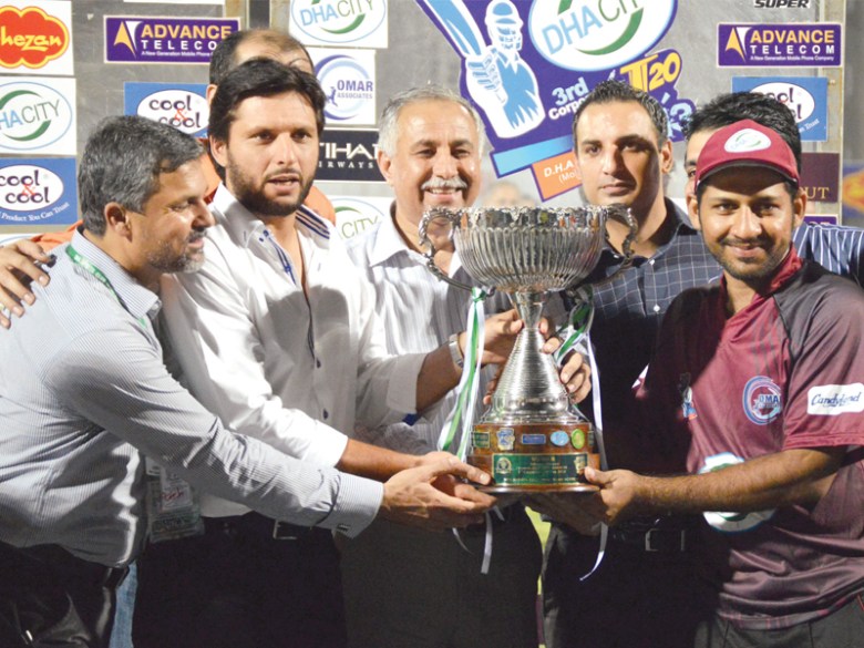 Omar Associates captain Sarfraz Ahmed was presented with the Corporate T20 Cup trophy by Pakistan all-rounder Shahid Afridi. PHOTO: TOURNAMENT ORGANISERS