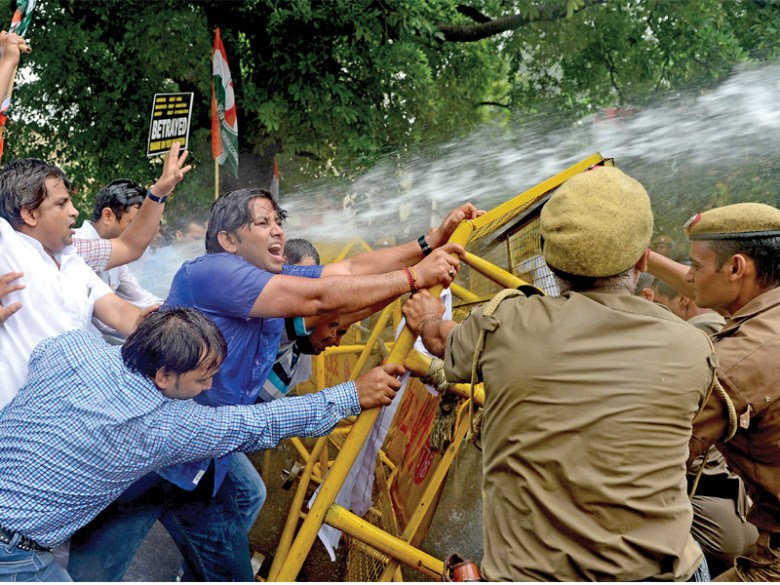 A stream of water from a police water cannon covers Indian Youth Congress activists as  they stage a violent protest near the Pakistan High Commission in New Delhi. PHOTO: AFP