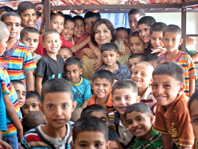 Boys pose for a photograph with Sonia Shahid. PHOTO: MYRA IQBAL/EXPRESS