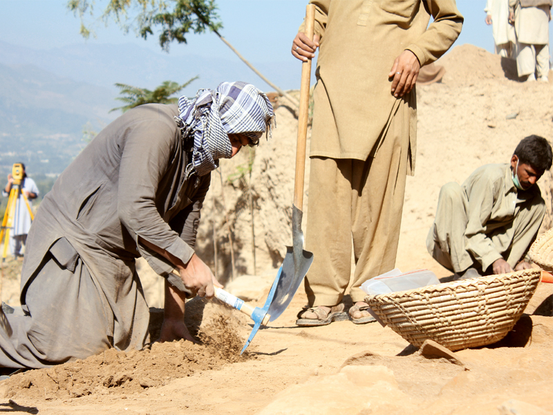 A team of archaeologists from Hazara University in Mansehra excavating in Udegram, Swat.