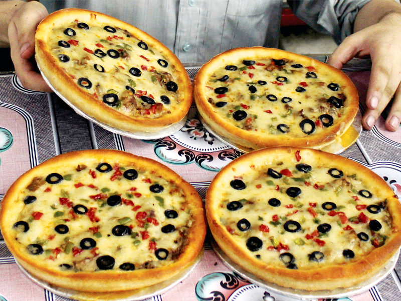 Pizza is becoming more popular in Peshawar, but only two major joints offer it. PHOTO: MUHAMMAD IQBAL
