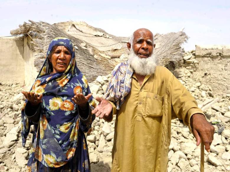 Survivors plead for help in front of their destroyed house in Awaran. PHOTO: AFP