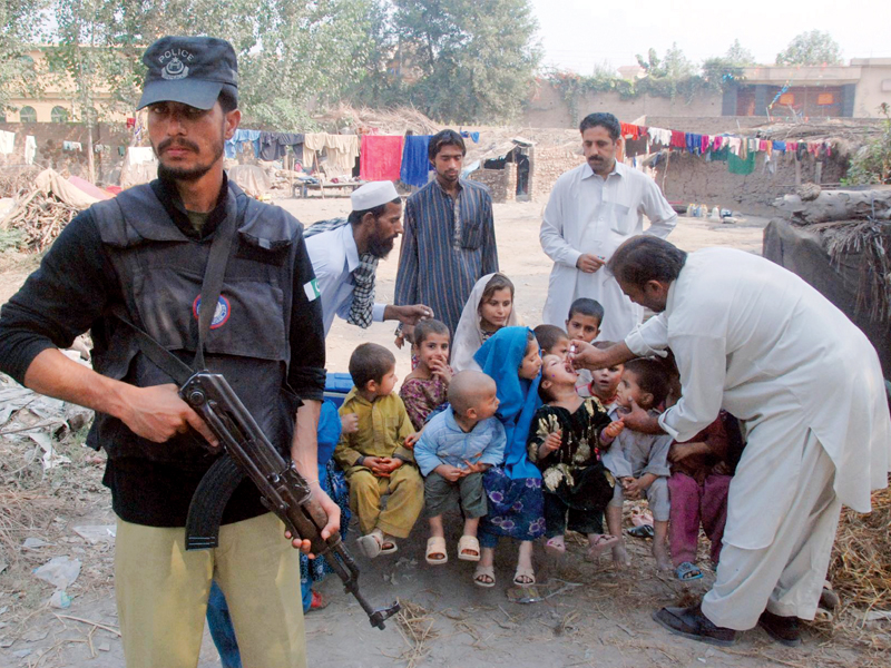 Children receive polio vaccination at Doranpur, near Peshawar-Islamabad motorway, on World Polio Day. PHOTO: SAMEER RAZIQ/EXPRESS
