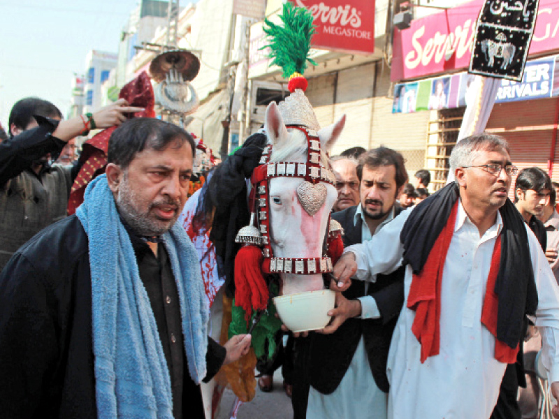 A Muharram procession that left Hussainia Imambargah passes through Saddar Road in Peshawar. PHOTO: MUHAMMAD IQBAL/EXPRESS