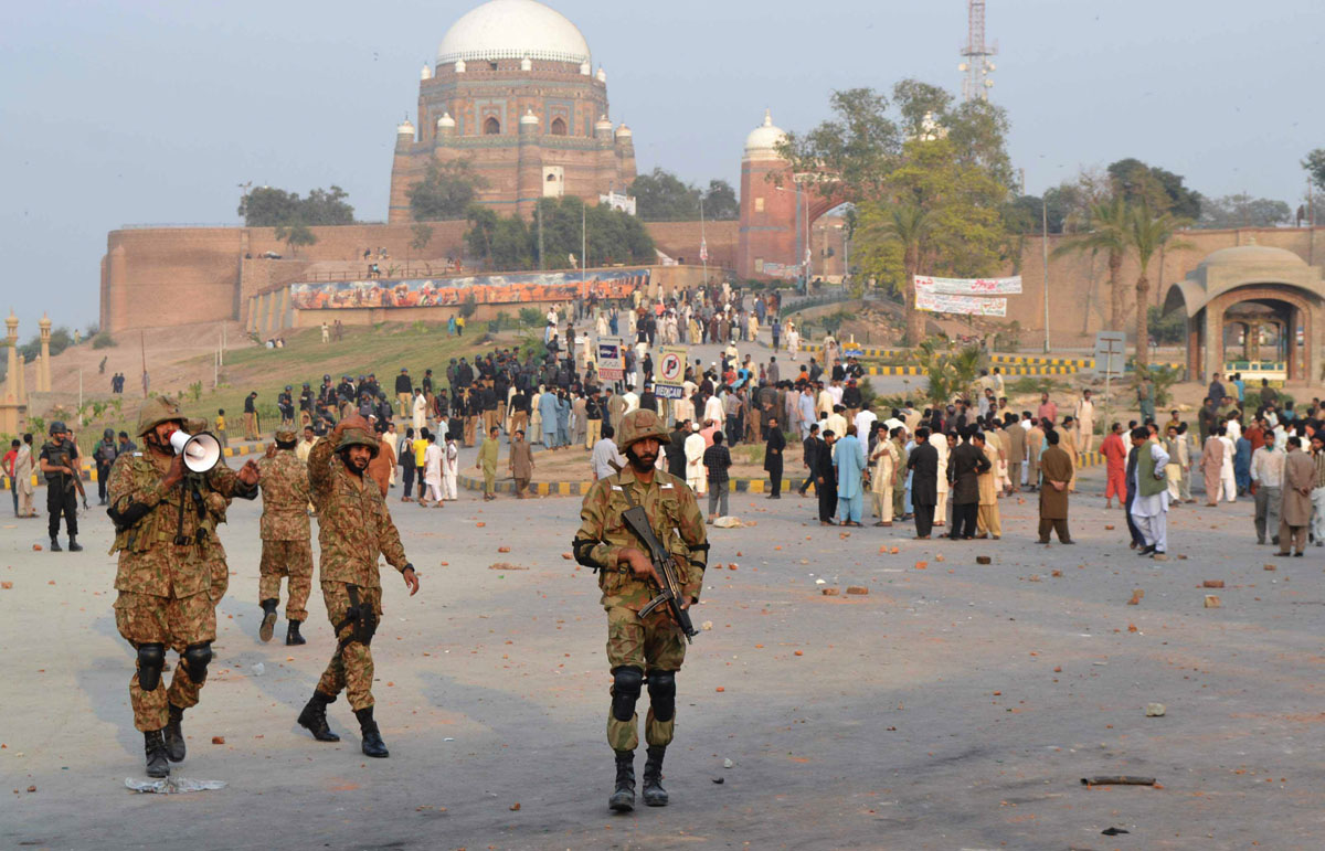Army units (foreground) deployed along with heavy contingents of police (background) in Multan following clashes. PHOTO: SHAHID SAEED/EXPRESS