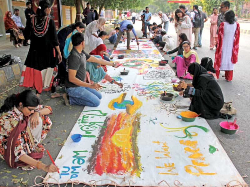 Students, artists and other participants took part in the interactive mural painting, titled Aik aur jahan mumkin hai, at the road adjacent to NAPA and the Arts Council. PHOTO: AYESHA MIR/EXPRESS, ATHAR KHAN/EXPRESS