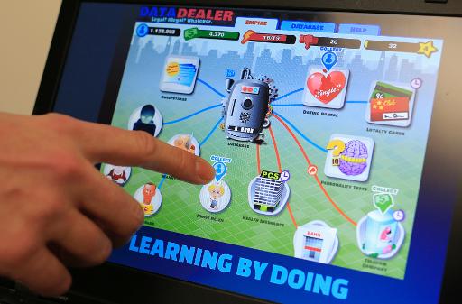 A man points out an icon in the "Data Dealer" game, on a laptop screen in Vienna on November 21, 2013. PHOTO: AFP