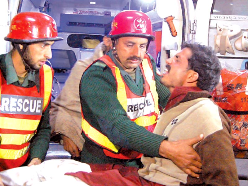 Rescuers shifting an injured person. PHOTO: MUHAMMAD JAVAID/EXPRESS