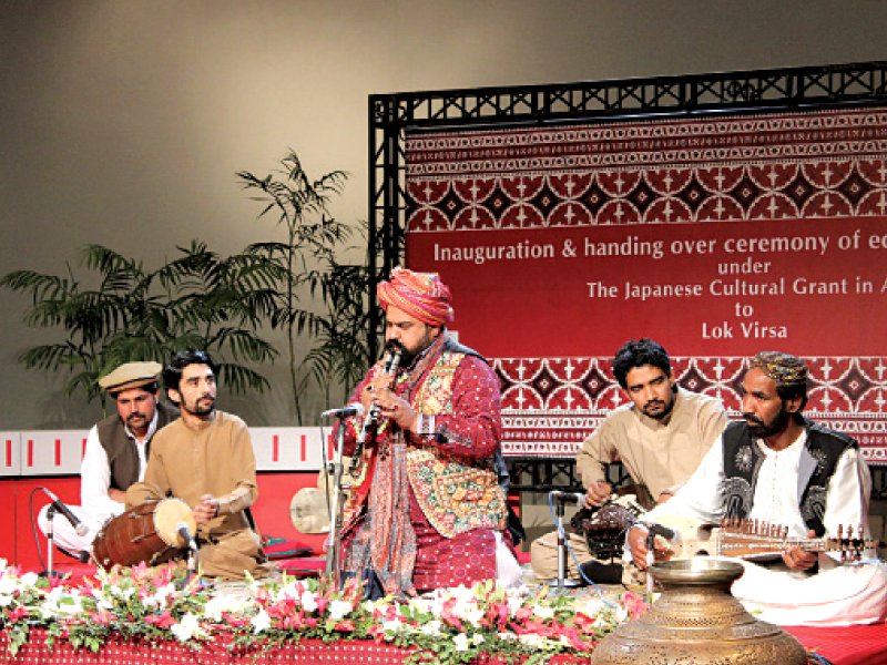 Baloch and Sindhi folk artists perform at the handing over ceremony of digital equipment. PHOTO: EXPRESS