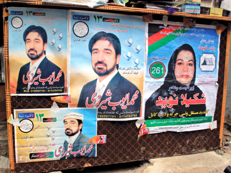 Posters of Afghan presidential candidates cover shop fronts in Mohallah Jangi. PHOTO: MUHAMMAD IQBAL/EXPRESS