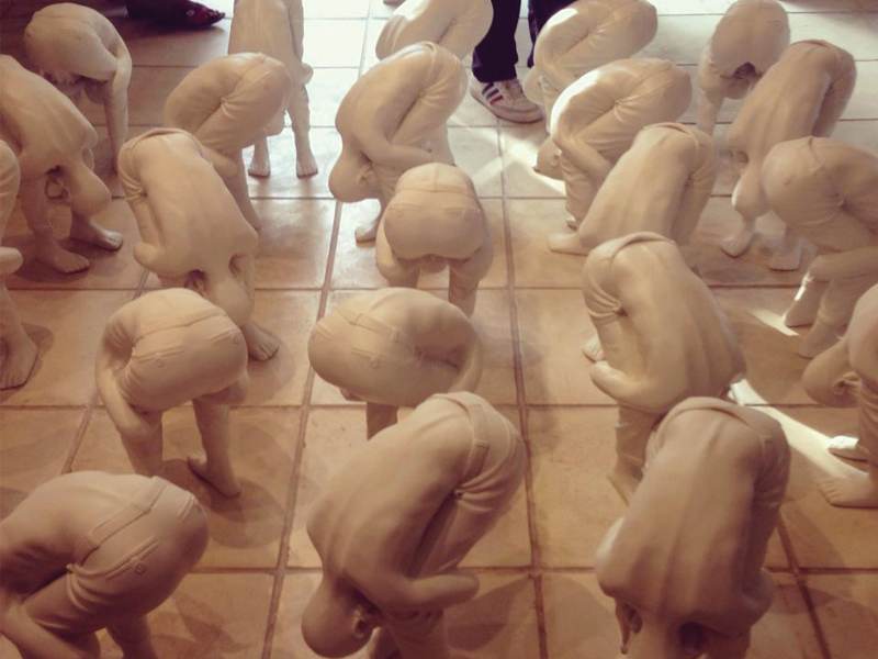 Fahim Rao has made ornaments out of his childhood memories. He made standing murghas out of fiberglass to represent the punishment he had to face for disobedience when he was in school. PHOTO COURTESY: KOEL GALLERY