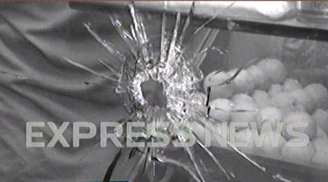 A screen shot showing a bullet hole in the glass of the sweet shop.