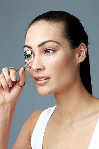 Start by curling the top lashes; begin at the root of the lashes and be careful not to get any skin into the eyelash curler.