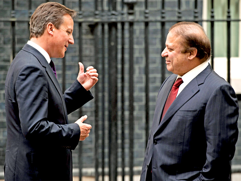 British PM David Cameron greets Nawaz Sharif outside 10 Downing Street in central London. PHOTO: AFP