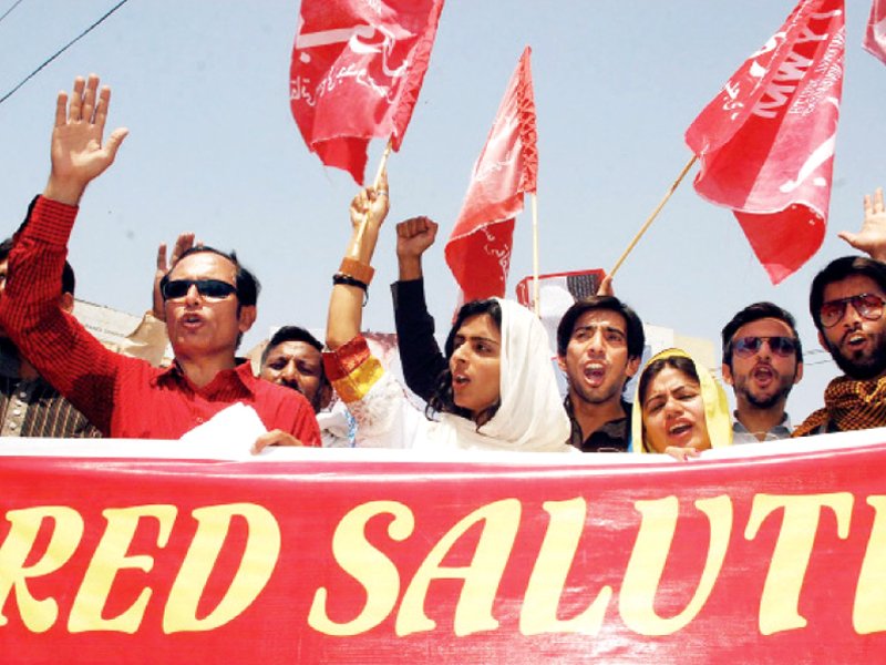 Activists and unionists hold banners and chant slogans to mark International Labour Day. PHOTO: ABID NAWAZ/EXPRESS, INP