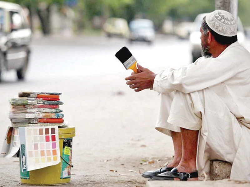 A daily wage labourer sits in wait for employment. PHOTO: FILE
