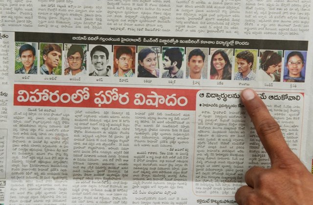 A parent points to a photograph of a missing student, feared drowned in the Beas River published in a local newspaper on June 9, 2014. PHOTO: REUTERS
