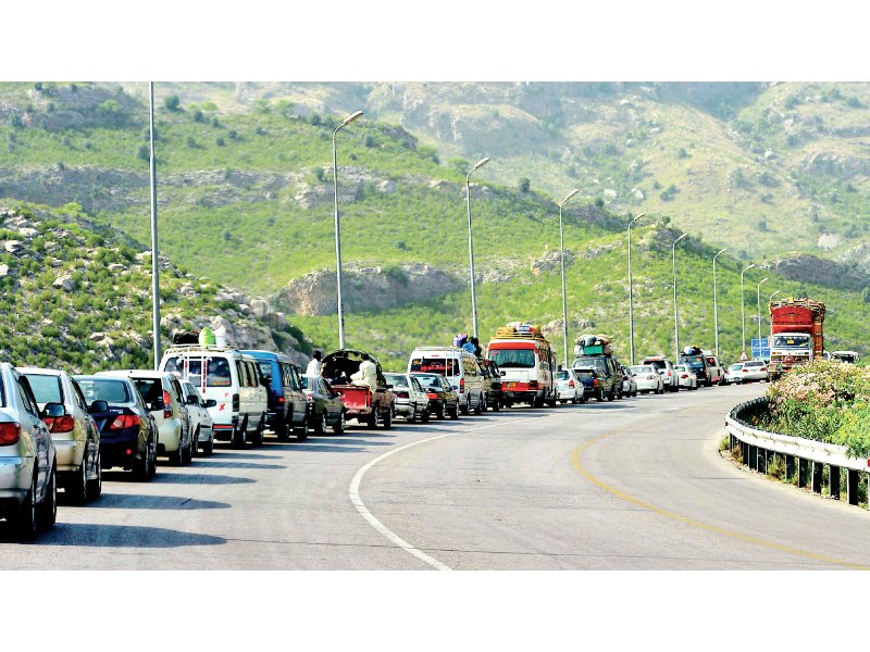 Queues of cars and vans carrying tribesmen from North Waziristan wait to clear Darra Adam Khel check post. PHOTO: AFP