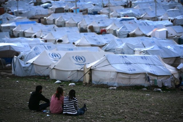 A file picture taken on February 13, 2014, shows Syrian-Kurdish refugees siting in the Quru Gusik (Kawergosk) refugee camp, 20 kilometres east of Arbil, the capital of the autonomous Kurdish region of northern Iraq.