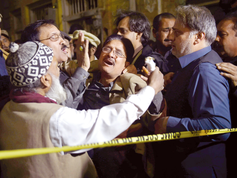 Relatives of victims mourn outside the site of a blast in Rawalpindi. PHOTO: AFP