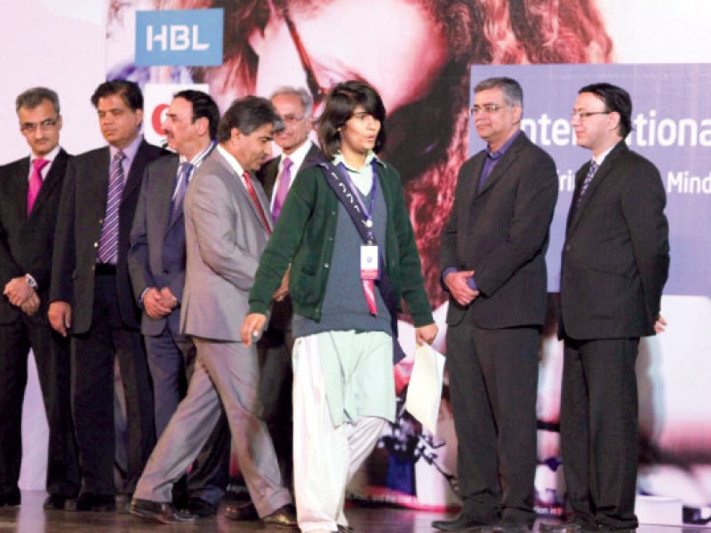 A young student walks off stage after collecting her certificate at the event. PHOTO: MUHAMMAD JAVAID/EXPRESS