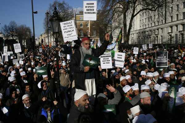 Muslim demonstrators hold placards during a protest against the publication of cartoons depicting the Prophet Mohammad in French satirical weekly Charlie Hebdo, near Downing Street in central London February 8, 2015. At least 1,000 British Muslims protested in central London on Sunday against what they called "insulting depictions" of the Prophet Mohammad by French newspaper Charlie Hebdo. The event comes weeks after 17 people were killed in three days of violence last month in France that began when two Islamist gunmen burst into Charlie Hebdo's Paris offices, opening fire in revenge for its publication of satirical images of Mohammad. Sunday's protest organisers condemned the Paris attacks, but said the magazine should not publish cartoons of the prophet. PHOTO: REUTERS