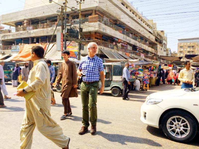 Enrique Penalosa walks along MA Jinnah Road on Thursday. The BRTS expert is in Pakistan to garner support for the system and work with entities such as the ADB and Bahria Town who are in a race to build Karachi's first corridor. PHOTO: MAHIM MAHER/EXPRESS