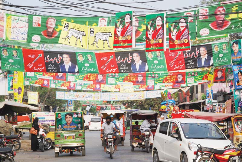 Campaign posters are displayed in Cantonment. PHOTO: RIAZ AHMAD/EXPRESS