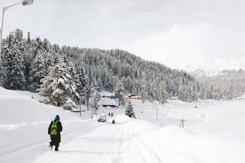 A Kashmiri boy walks down a road in Gulmarg, known to be  a world-class skiing destination.  PHOTOS: HAZIQ QADRI
