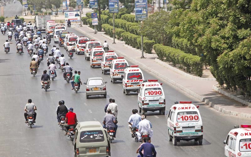 Ambulances transport the bodies to the graveyard on Thursday. PHOTO: ONLINE