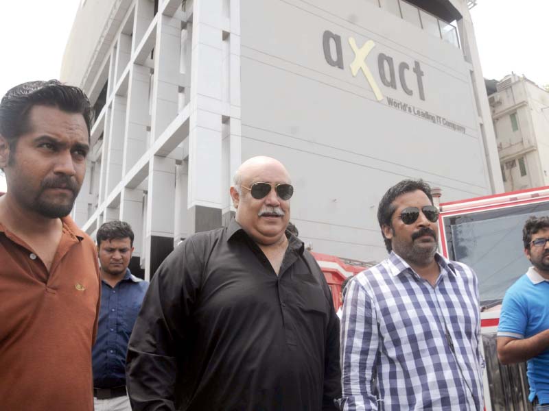 The FIA deputy director leaves the Axact HQ in Karachi after a raid. PHOTO: EXPRESS
