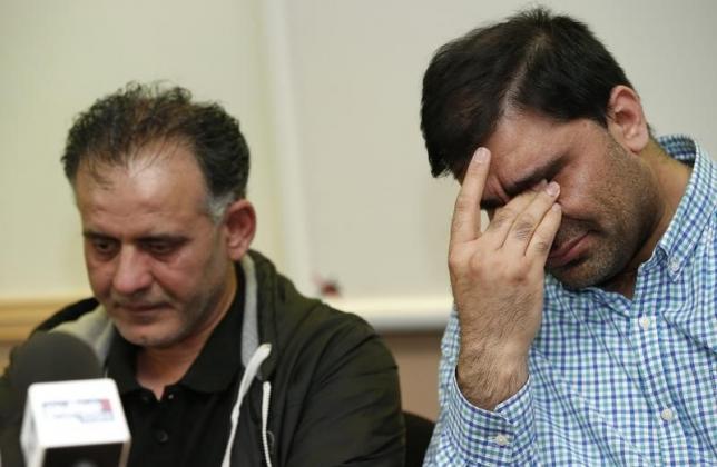 Akhtar Iqbal (L), the husband of Sugra Dawoodman and Mohammed Shoaib, the husband of Khadija Bibi dawood react during a news conference at a solicitors office in Bradford, Britain, June 16, 2015. PHOTO: REUTERS