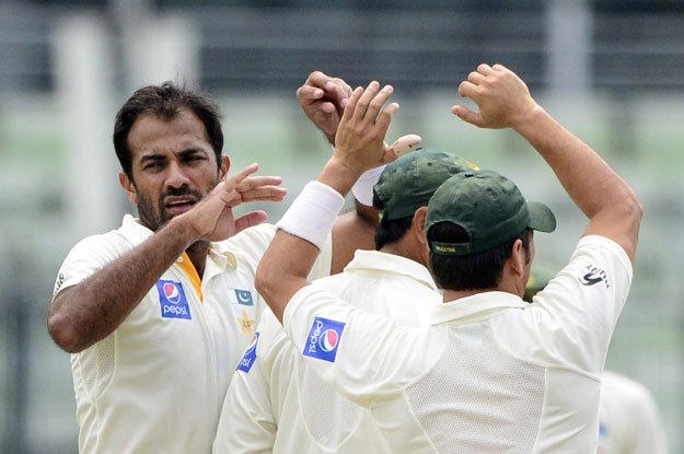 Wahab Riaz (L) celebrates with teammates after the dsimissal of unseen Bangladesh batsman Shuvagata Hom during the third day of the second cricket Test match between Bangladesh and Pakistan at The Sher-e-Bangla National Cricket Stadium in Dhaka on May 8, 2015. PHOTO: AFP