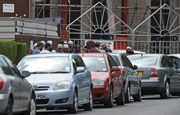 Men congregate outside the Markazi mosque in Savile Town, Dewsbury on July 5, 2015 PHOTO: AFP