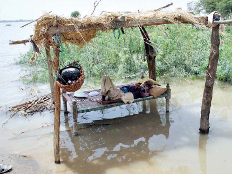 Some residents of flood-stricken areas have taken it upon themselves to evacuate their families to higher ground. Others, like this man, have chosen to stay back in hopes that the flood will pass within the next few days. PHOTO: APP