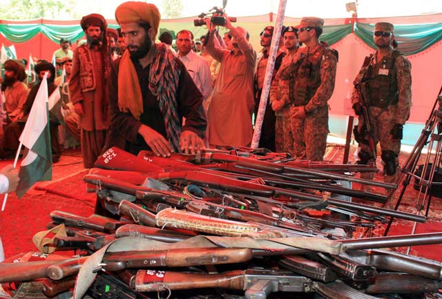 The fighters surrendered their weapons during an Independence Day ceremony at Police Lines in Quetta. PHOTO: INP