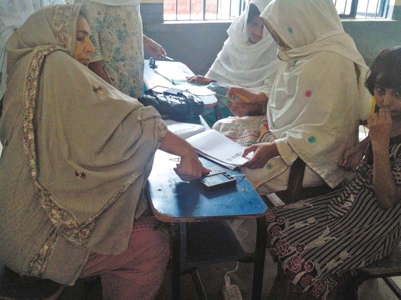 Women take part in the polling process during by election in Haripur. PHOTO: EXPRESS