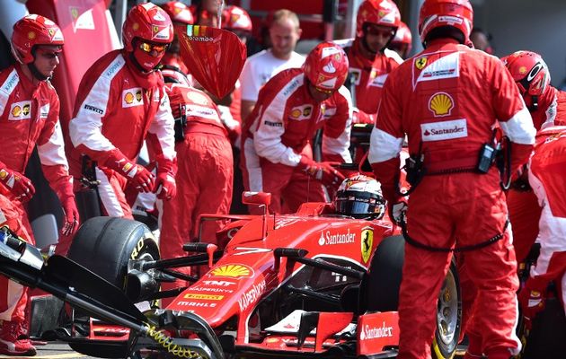 Mechanics work on the car of Ferrari's German driver Sebastian Vettel in the pits at the Spa-Francorchamps circuit in Spa on August 23, 2015, during the Belgian Formula One Grand Prix. PHOTO: AFP